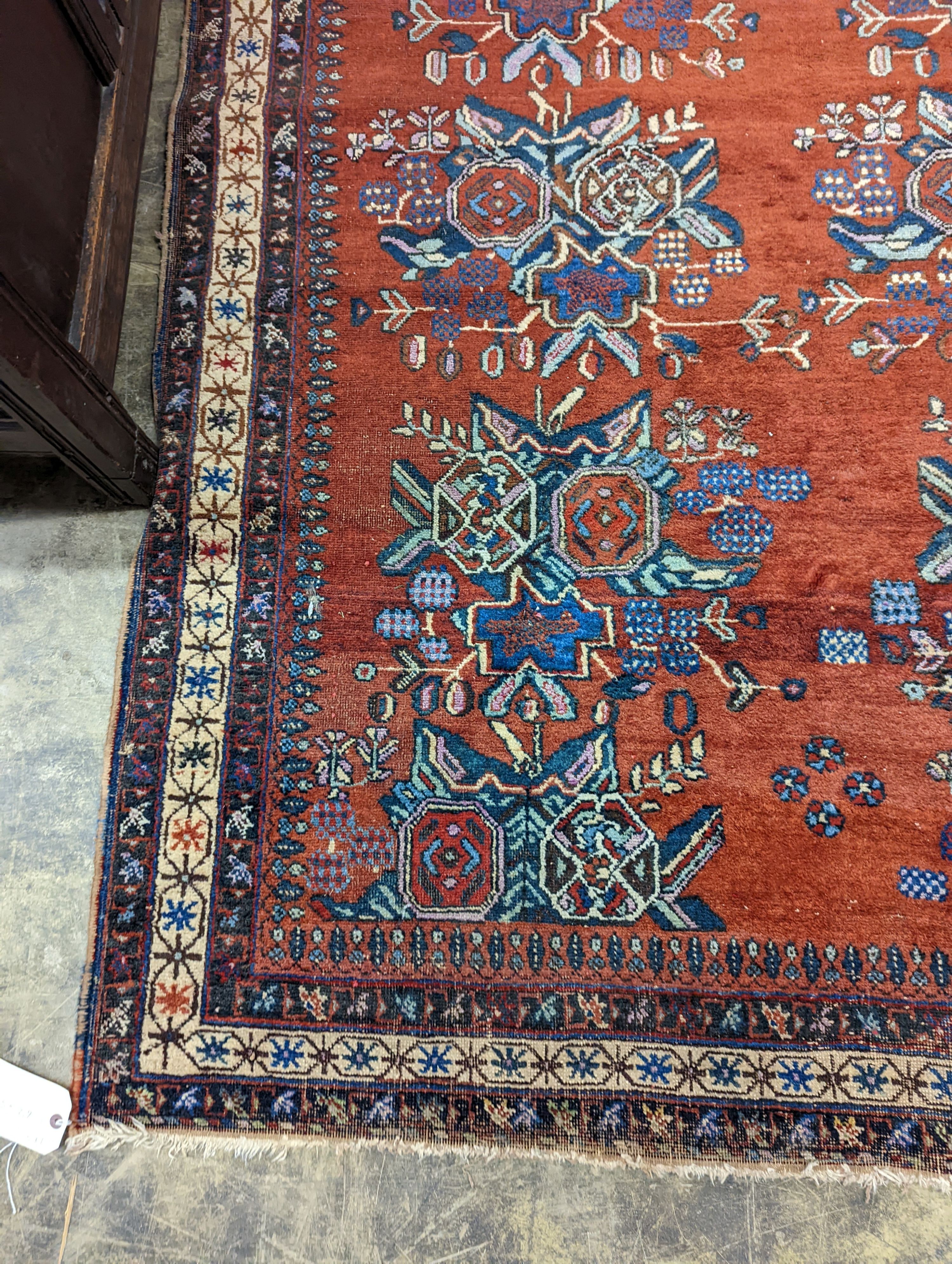 A North West Persian red ground rug with stylised foliate motifs, 185 x 157cm